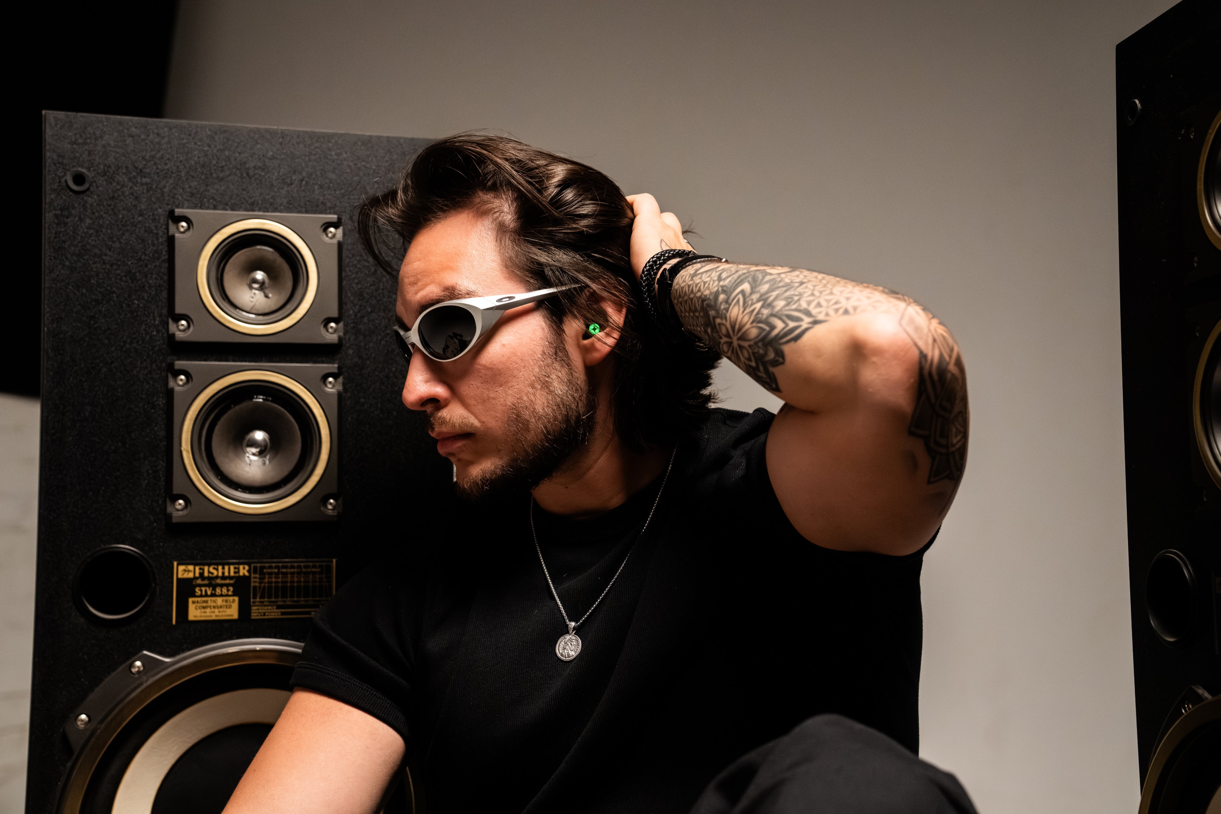 Person wearing LUMENEARZ near retro speakers